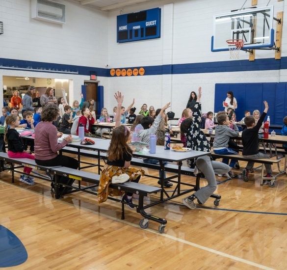 students sitting in a gymnasium eating lunch at salem lutheran school in Greenfield, MN